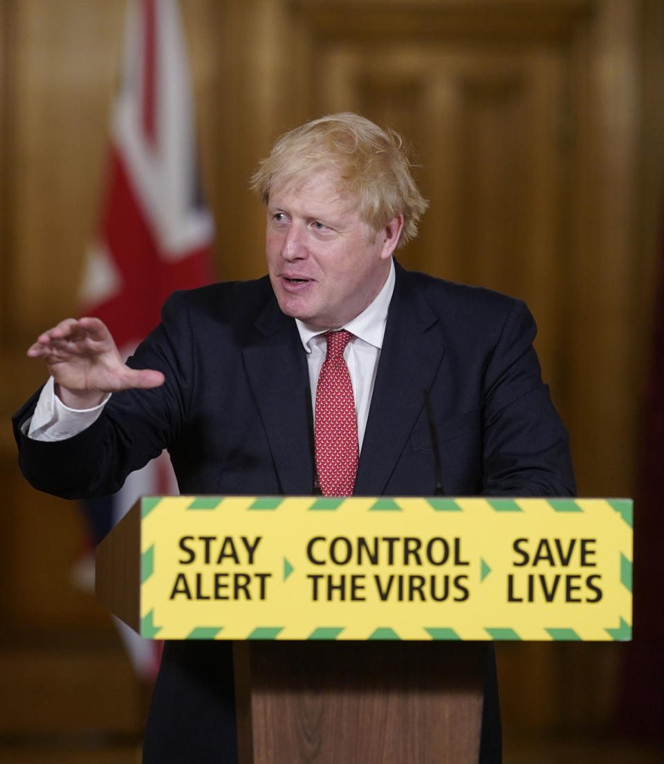 In this handout photo provided by 10 Downing Street, Britain's Prime Minister Boris Johnson speaks during a media briefing on coronavirus in Downing Street, London, Friday, July 17, 2020. Johnson has announced a further easing of the country's lockdown, and that people will no longer be told to work from home and avoid public transit. That move appears at odds with the views of his chief scientific adviser, who said Thursday that there was “absolutely no reason” to change the work-from-home advice. (Andrew Parsons/10 Downing Street via AP)