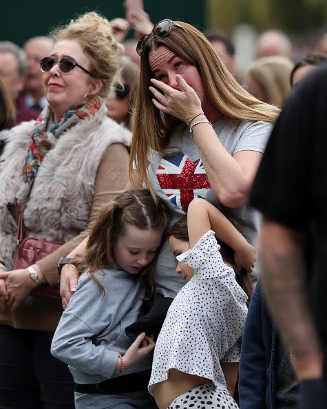 WINDSOR, ENGLAND - SEPTEMBER 19: Members of the public show their emotion on The Long Walk on September 19, 2022 in Windsor, England. The committal service at St George's Chapel, Windsor Castle, took place following the state funeral at Westminster Abbey. A private burial in The King George VI Memorial Chapel followed. Queen Elizabeth II died at Balmoral Castle in Scotland on September 8, 2022, and is succeeded by her eldest son, King Charles III. (Photo by Alex Pantling/Getty Images)