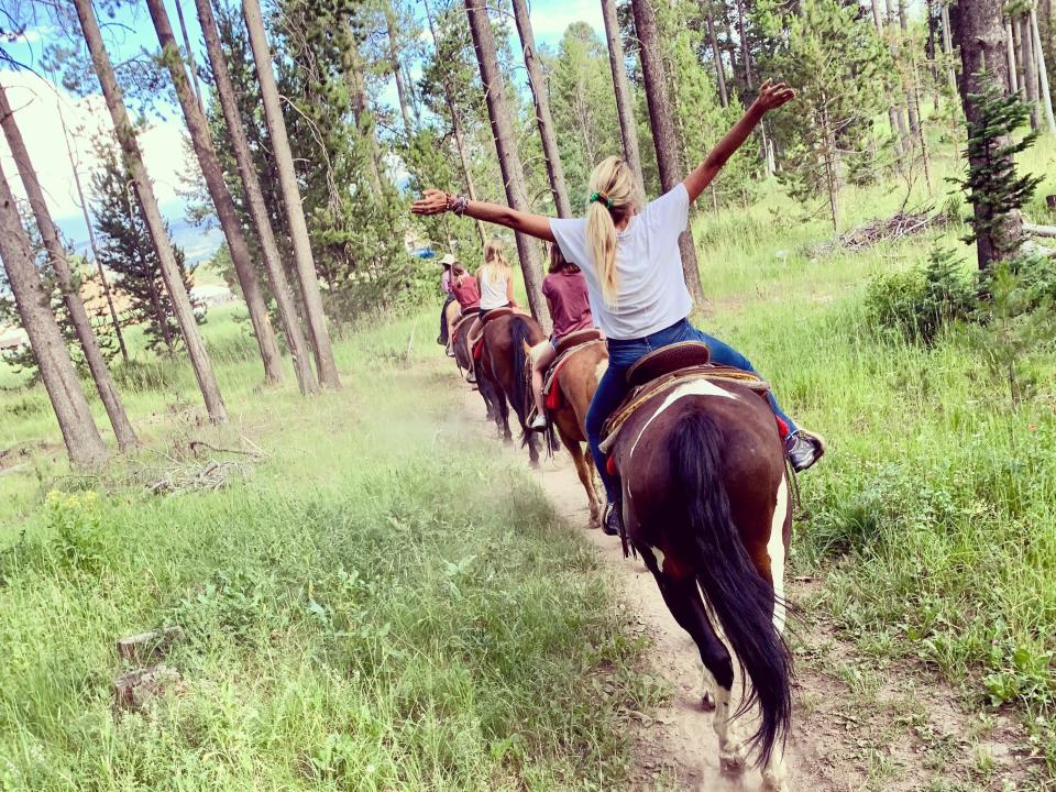 A picture of people on horseback in a forest in Idaho