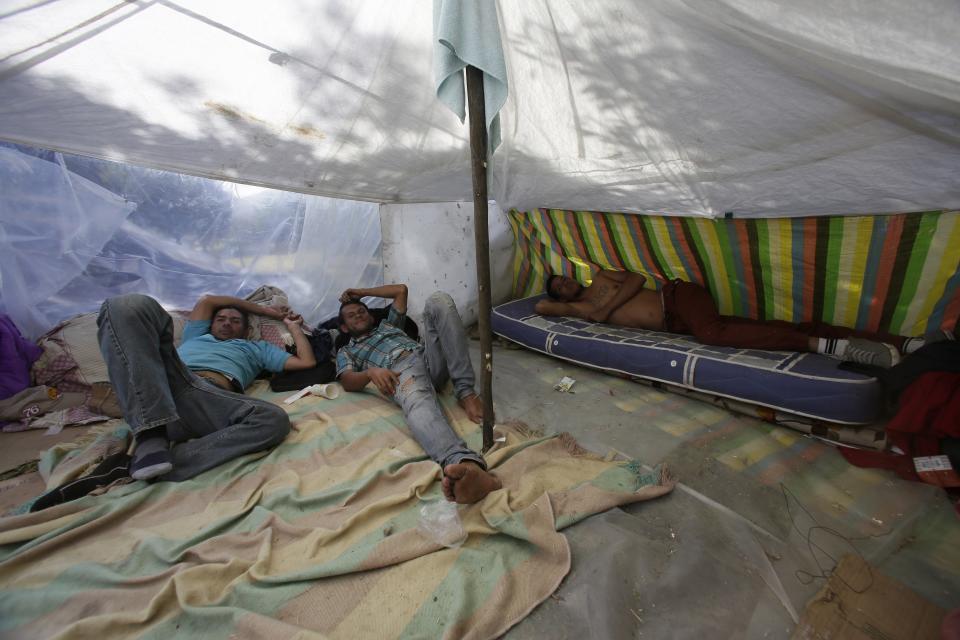 <p>Venezuelan migrants rest at a makeshift tent in Quito, Ecuador, Thursday, Aug. 9, 2018. (Photo: Dolores Ochoa/AP) </p>