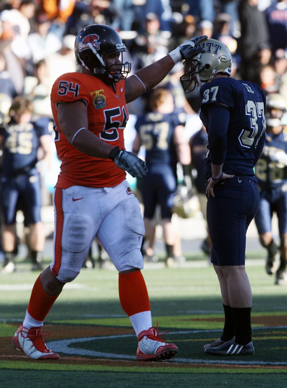 Defensive lineman Stephen Paea of Oregon State, left, pats kicker Conor Lee of Pitt on the helmet after Lee missed a 58-yard field goal attempt Dec. 31, 2008. No. 24 Oregon State beat No. 18 Pittsburgh 3-0.