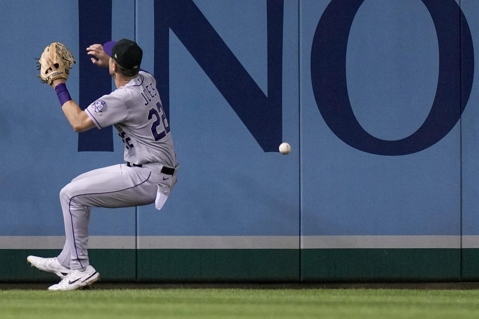 Colorado Rockies left fielder Nolan Jones lets a ball bounce off the outfield wall hit by Washington Nationals designated hitter Joey Meneses for a double during the fourth inning of a baseball game at Nationals Park, Tuesday, July 25, 2023, in Washington. (AP Photo/Alex Brandon)