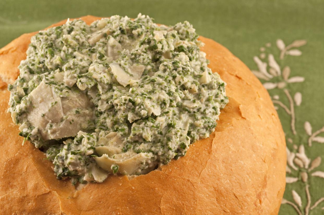 Spinach and artichoke dip in sourdough bread bowl.