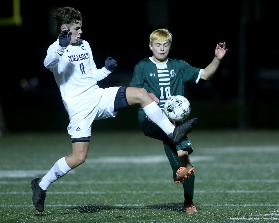 Cohasset's Zach Smith leaps out and tries to win the ball from Abington's Cole Lindo during first half action of their Round of 16 game against Abington in the Division 4 state tournament at Abington High on Wednesday, Nov. 9, 2022. Cohasset would win 3-2 in OT. 