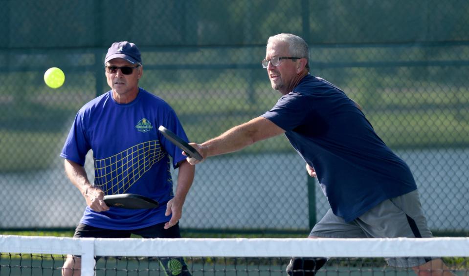 John Neff and Steve Rebillot start their morning with a game at the pickleball courts at Stadium Park in Canton.