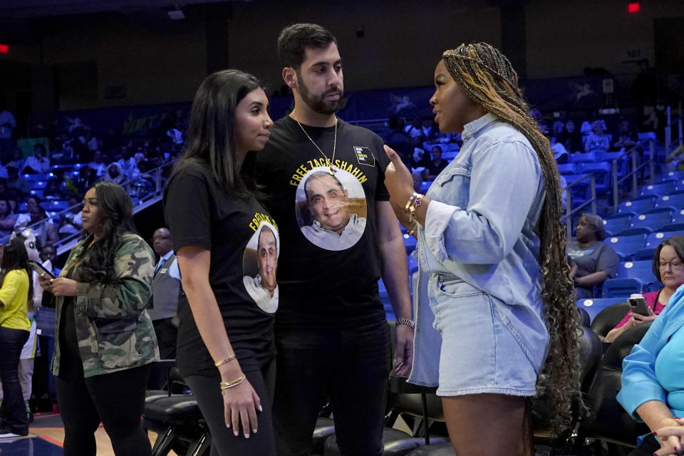 Cherelle Griner, right, wife of Brittney Griner, talks with Meera Shahin, left, and her fiance, Joshua Karam, center, before a WNBA basketball game between the Phoenix Mercury and Dallas Wings, Wednesday, June 7, 2023, in Arlington, Texas. Shahin's father, Zack Shahin, is detained in the United Arab Emirates. (AP Photo/Tony Gutierrez)