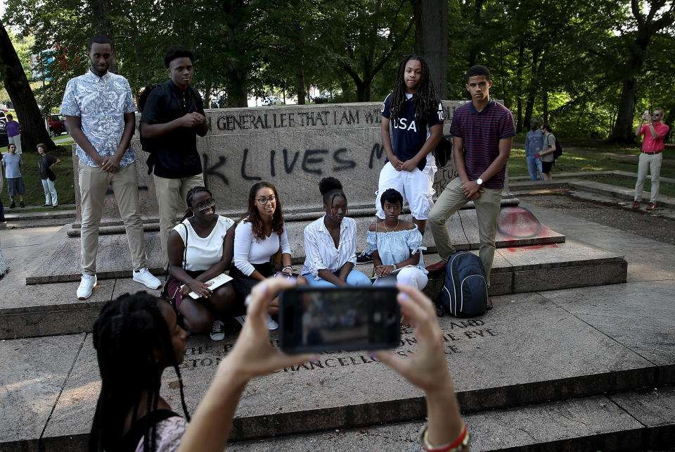 A student tour group poses for a photo at the site where a statue dedicated to Robert E. Lee and Thomas 'Stonewall' Jackson stood.&nbsp; (Photo: Win McNamee via Getty Images)