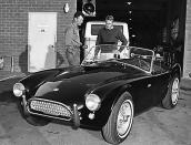 Actor Steve McQueen discusses the AC Cobra with Carroll Shelby at the Shelby American plant in Venice, California.