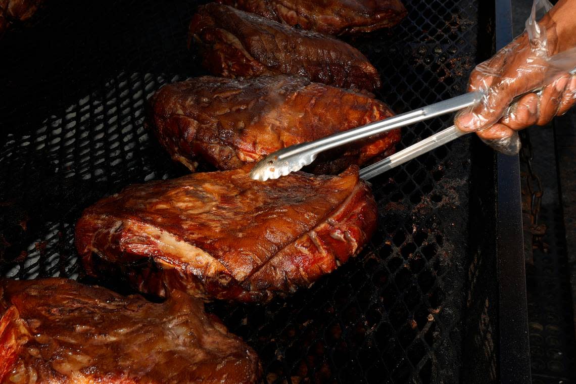 Milton Zanders tends to smoked pork on his grill outside True BBQ on Friday April 19, 2024. The restaurant is in the Triangle City area of West Columbia.