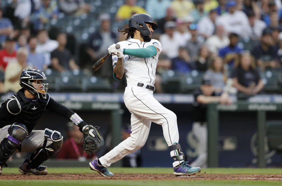 Seattle Mariners' J.P. Crawford hits an RBI single against the Colorado Rockies during the fifth inning of a baseball game, Tuesday, June 22, 2021, in Seattle. (AP Photo/John Froschauer)