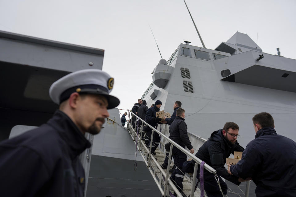 French sailors form a chain to load supplies on board of the French navy frigate Normandie during a port call in a Norwegian fjord, north of the Arctic circle, Friday March 8, 2024. The French frigate is part of a NATO force conducting exercises in the seas, north of Norway, codenamed Steadfast Defender, which are the largest conducted by the 31 nation military alliance since the cold war. (AP Photo/Thibault Camus)