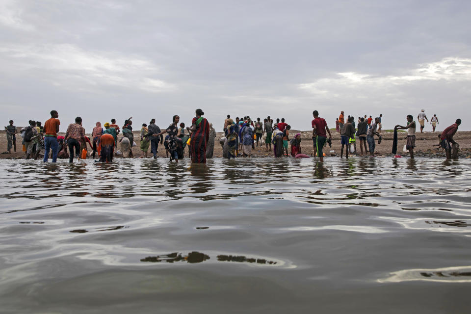 In this July 26, 2019 photo, Ethiopian migrants walk on the shores of Ras al-Ara, Lahj, Yemen, after disembarking from a boat. According to the U.N.'s International Organization for Migration the number of women making the trip jumped from nearly 15,000 in 2018 to more than 22,000 in 2019. The number of girls had an enormous increase, quadrupling from 2,075 to 8,360. Despite the many risks – smugglers' exploitation, hunger, drowning – they are undaunted. (AP Photo/Nariman El-Mofty)