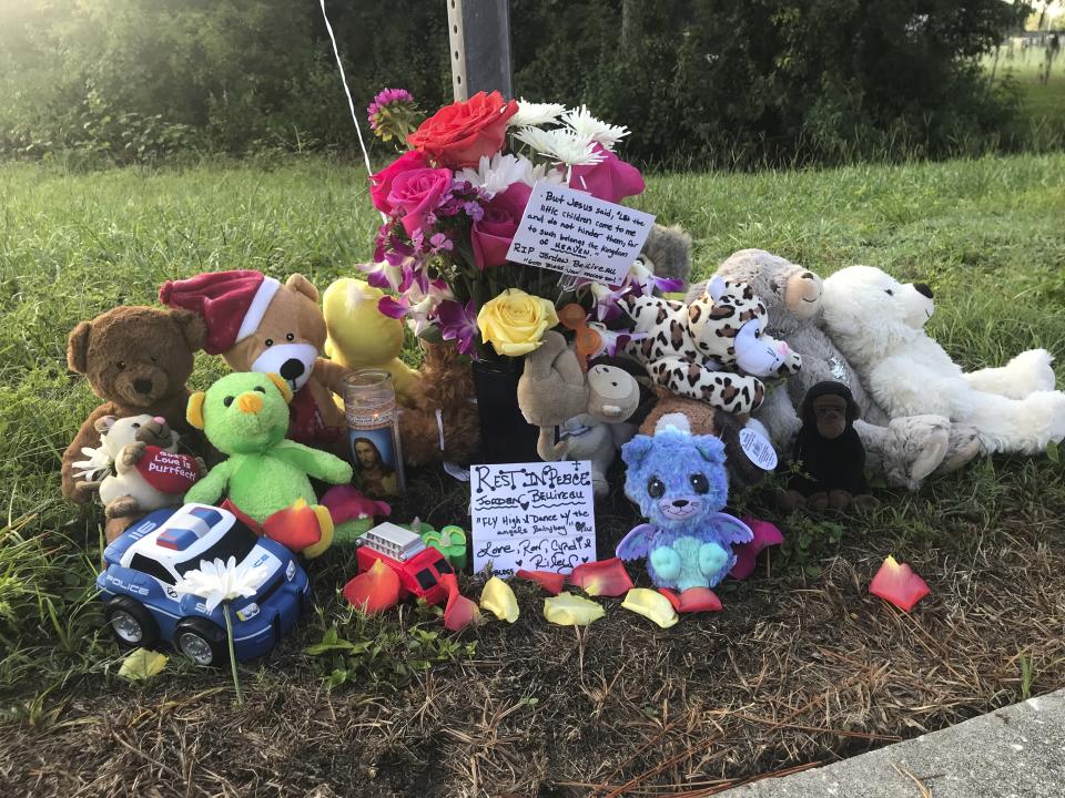 A memorial for Jordan Belliveau, a 2-year-old boy who was found dead in the woods on Tuesday, sits at Lake Avenue NE and McMullen Road, Wednesday, Sept. 5, 2018, in Largo, Fla. Largo police arrested the boys mother, 21-year-old Charisse Stinson, late Tuesday. She's charged with first-degree murder in the death of Jordan Belliveau and is being held in the Pinellas County Jail. (Kathryn Varn/Tampa Bay Times via AP)