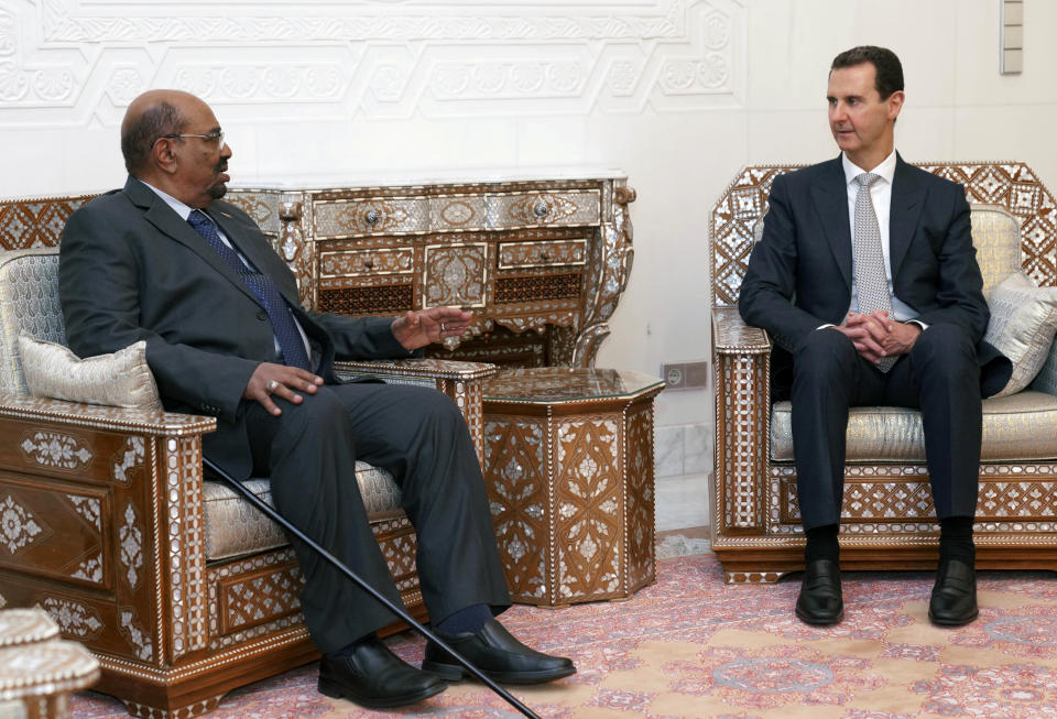 In this photo released by the Syrian official news agency SANA, Syrian President Bashar Assad, right, meets with Sudan's President Omar al-Bashir in Damascus, Syria, Sunday, Dec. 16, 2018. Sudan's president has become the first Arab League leader to visit Syria since a war erupted there nearly eight years ago. (SANA via AP)