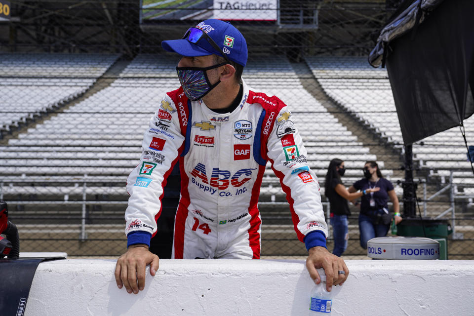 Tony Kanaan, of Brazil, looks down the pit lane during practice for the Indianapolis 500 auto race at Indianapolis Motor Speedway in Indianapolis, Friday, Aug. 14, 2020. (AP Photo/Michael Conroy)