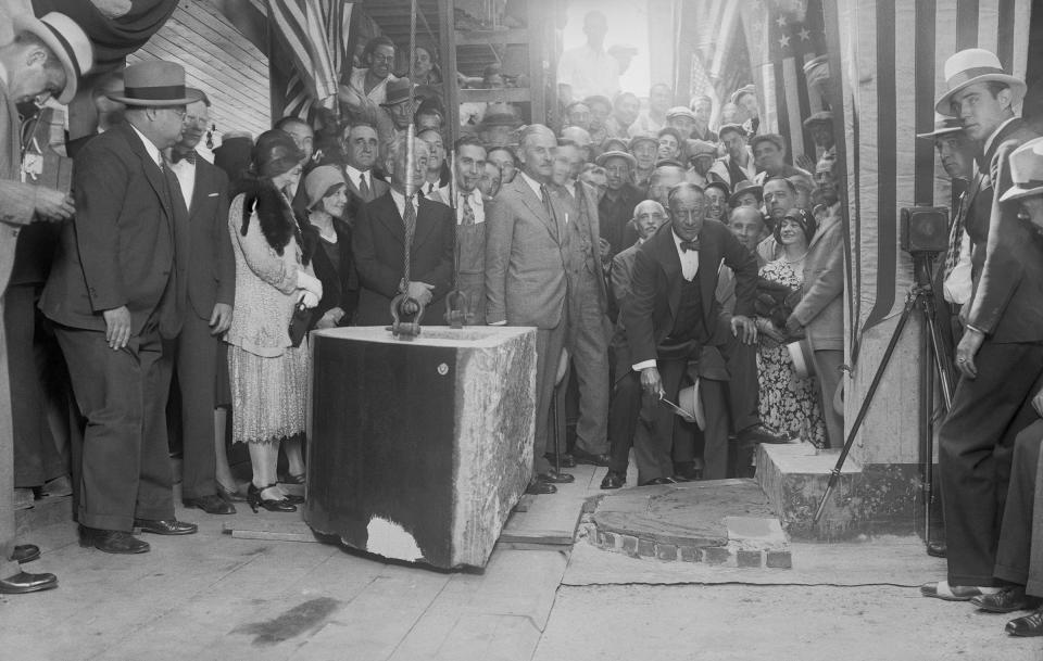 As possessor of a gold membership card in the bricklayers' union, Alfred Smith performed a thorough job when he laid the cornerstone for the Empire State Building on Fifth avenue and 34th street, New York City, before a crowd of onlookers on Sept. 9, 1930.<span class="copyright">Bettmann Archive/Getty Images</span>