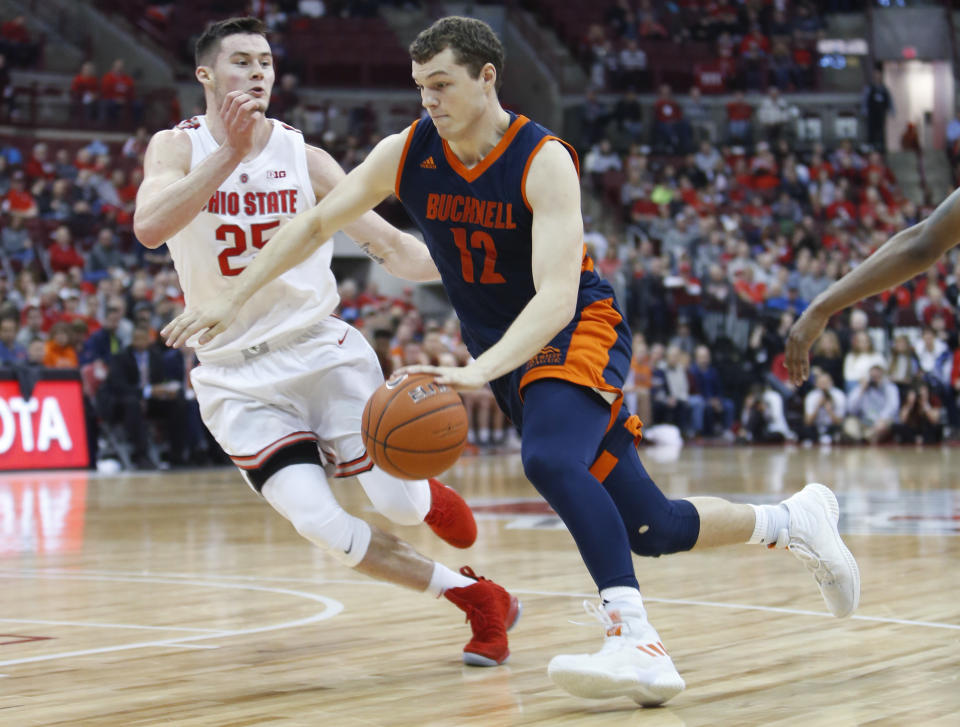 Bucknell's John Meeks, right, dribbles past Ohio State's Kyle Young during the first half of an NCAA college basketball game Saturday, Dec. 15, 2018, in Columbus, Ohio. (AP Photo/Jay LaPrete)