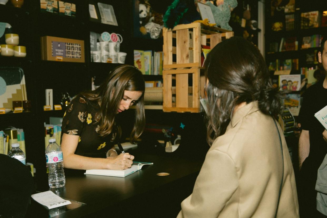 Sasha Sagan signing a copy of her book.