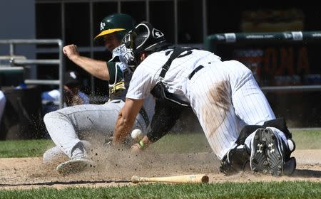 Jun 23, 2018; Chicago, IL, USA; Oakland Athletics right fielder Stephen Piscotty (25) slides safely into home plate under Chicago White Sox catcher Kevan Smith (36) in the eighth inning at Guaranteed Rate Field. Mandatory Credit: Matt Marton-USA TODAY Sports