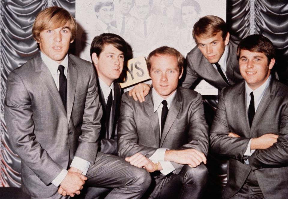 American pop group The Beach Boys pictured in 1964. Love sits centrally, with Wilson second from the left (Getty Images)