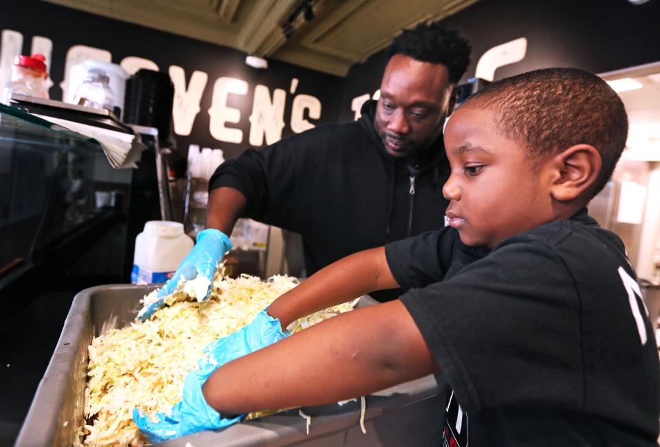 Jason Alston, left, prepares coldslaw with his son Noah, 4, at the chef's restaurant, Heaven’s Table  BBQ, 5507 W. North Ave.