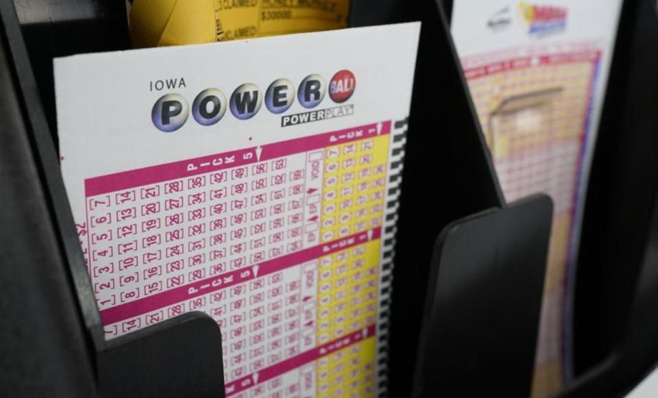 In this Jan. 12, 2021 file photo, blank forms for the Powerball lottery sit in a bin at a local grocery store, in Des Moines, Iowa. A Powerball ticket sold in Columbus recently was the winner of a $2 million jackpot.