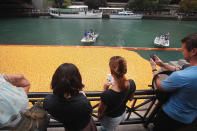 <p>Spectators watch as Rubber ducks float down the Chicago River during the Windy City Rubber Ducky Derby on August 3, 2017 in Chicago, Illinois. (Photo: Scott Olson/Getty Images) </p>