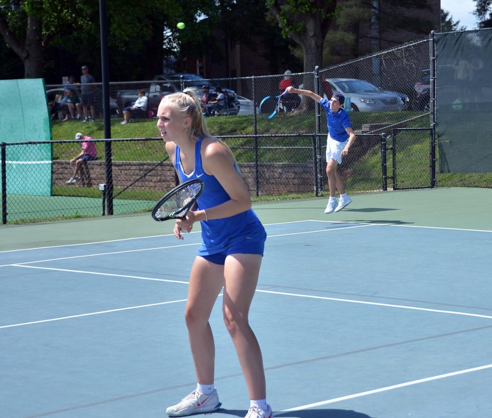 Clear Spring senior Andrew Keller serves as senior Kayda Shives waits at the net during the Maryland Class 1A mixed doubles final on May 28 at the Wilde Lake Tennis Club.