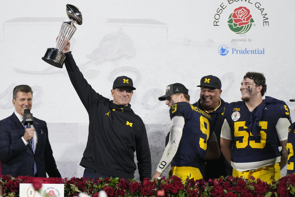 Michigan head coach Jim Harbaugh holds the winner's trophy after a win over Alabama in the Rose Bowl CFP NCAA semifinal college football game Monday, Jan. 1, 2024, in Pasadena, Calif. (AP Photo/Mark J. Terrill)