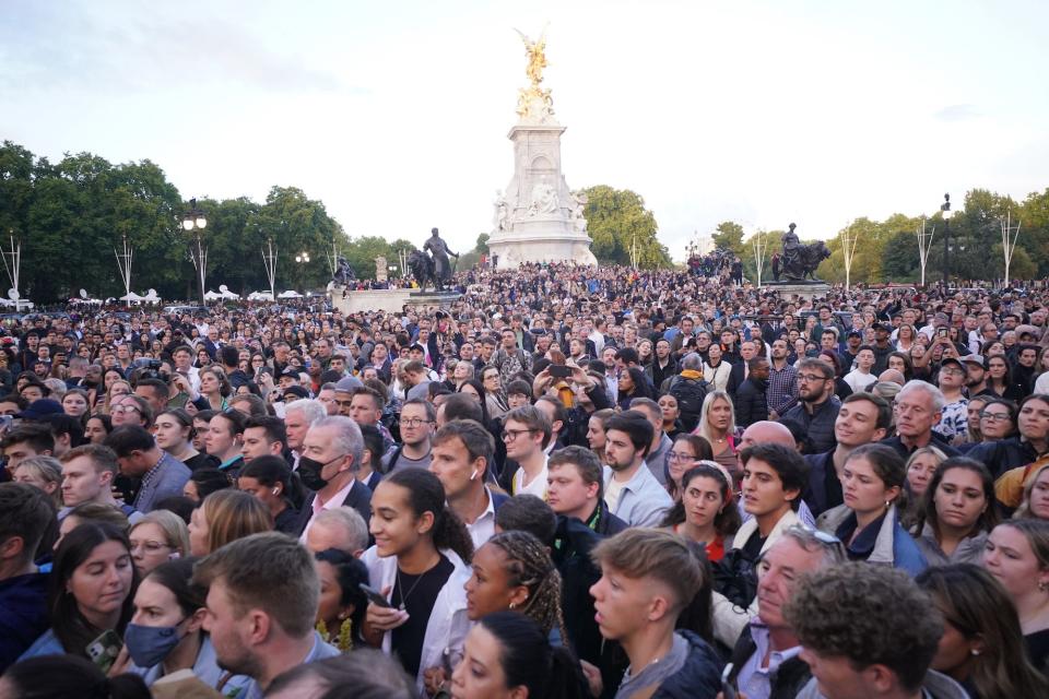 A crowd gathers at Buckingham Palace following Queen Elizabeth II's death.