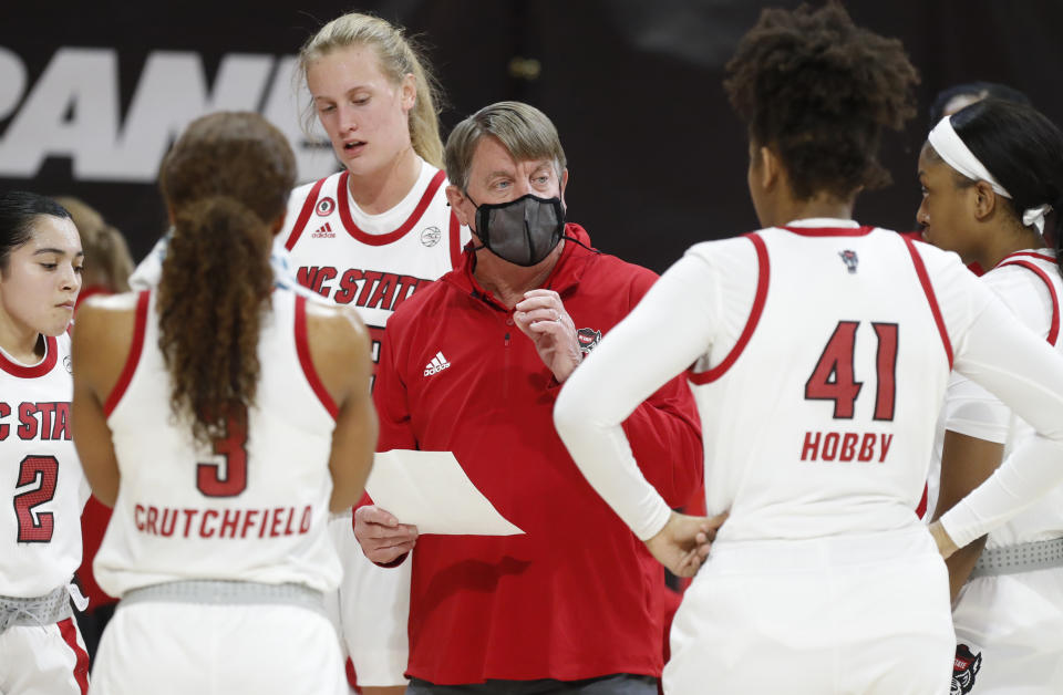 North Carolina State head coach Wes Moore talks with his team during the first half of an NCAA college basketball game against Clemson Reynolds Coliseum in Raleigh, N.C., Thursday, Feb. 11, 2021. (Ethan Hyman/The News & Observer via AP)