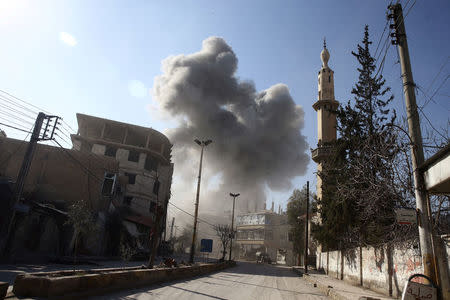 Smoke rises from the rebel held besieged town of Hamouriyeh, eastern Ghouta, near Damascus, Syria, February 21, 2018. REUTERS/Bassam Khabieh