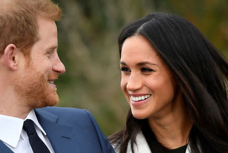 Britain's Prince Harry poses with Meghan Markle in the Sunken Garden of Kensington Palace, London, Britain, November 27, 2017. REUTERS/Toby Melville