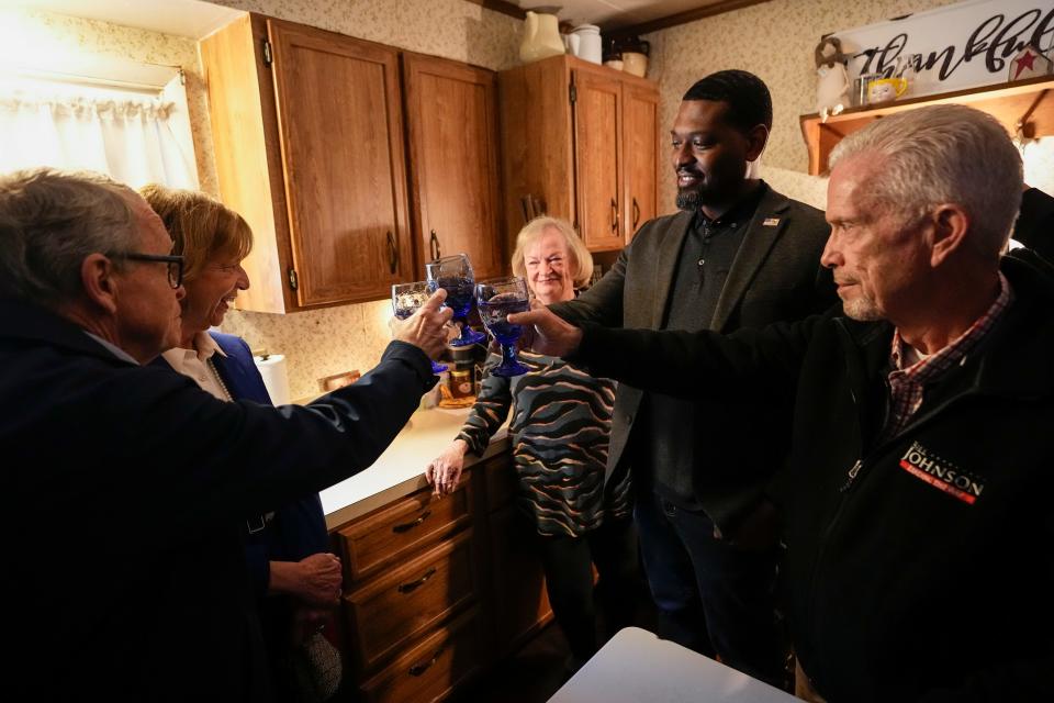 Feb 21, 2023; East Palestine, Ohio, USA;  EPA administrator Michael Regan toasts a glass of tap water with Ohio Gov. Mike DeWine and Congressman Bill Johnson as he visits the home of East Palestine resident Carolyn Brown, 79. First Lady Fran DeWine also made the visit. Work continues to clean up the vinyl chloride chemical spill from the Norfolk Southern train derailment on Feb. 3. Mandatory Credit: Adam Cairns-The Columbus Dispatch