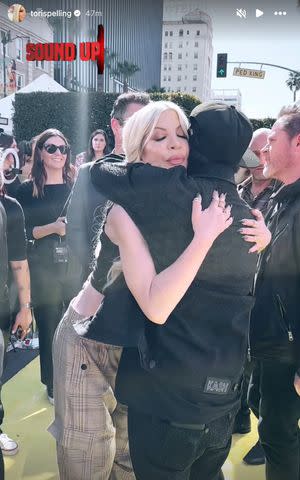 <p>Tori Spelling/Instagram</p> Tori Spelling and Flavor Flav exchange a hug