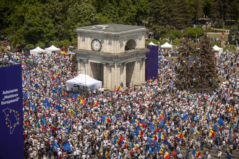 FILE - People holding European Union and Moldovan flags fill the Great National Assembly Square in Chisinau, Moldova, Sunday, May 21, 2023, at the end of a rally called by President Maia Sandu, aiming to show the country's support for European Union accession. Ukraine is set to officially launch membership talks with the European Union later on Tuesday, June 25, 2024. Moldova will also set its accession process in motion, as the EU hosts two intergovernmental conferences in Luxembourg. (AP Photo/Aurel Obreja, File)