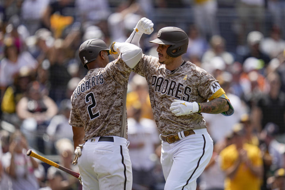 San Diego Padres' Manny Machado, right, celebrates with teammate Xander Bogaerts after hitting a home run during the third inning of a baseball game against the San Francisco Giants, Sunday, Sept. 3, 2023, in San Diego. (AP Photo/Gregory Bull)