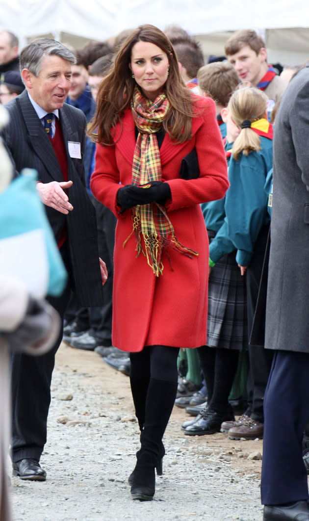 Kate Middleton kept her baby bump hidden in this bright red coat during a visit to Scotland. Copyright [Rex]