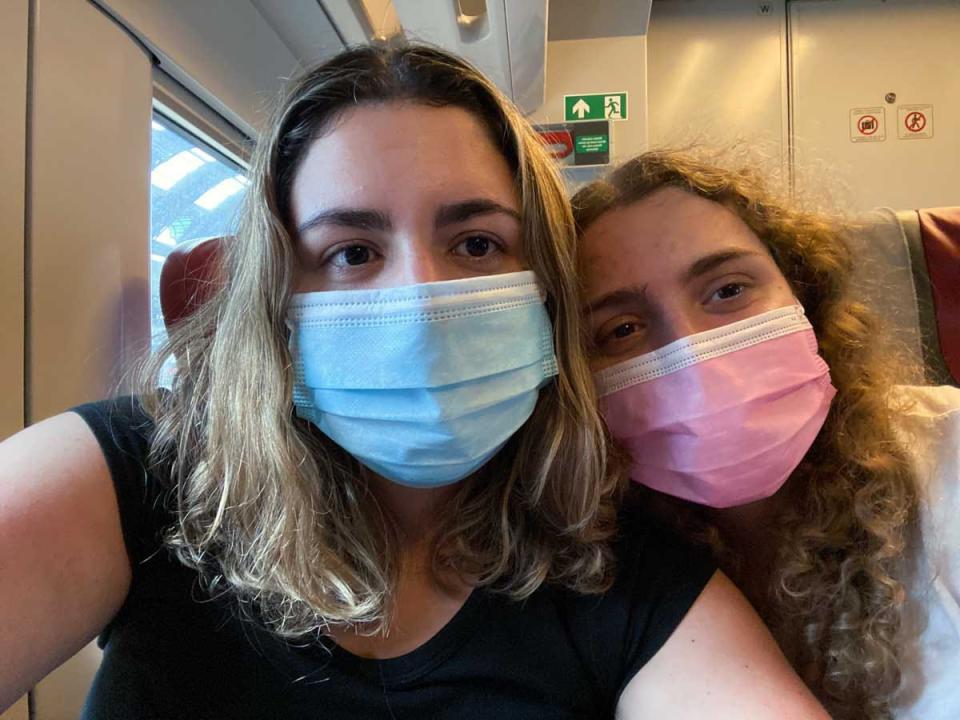 The writer and her sister on their flight from JFK to Milan during COVID.