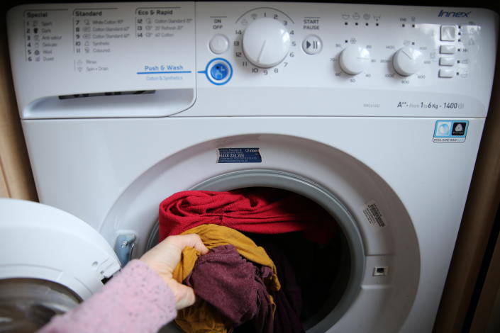 Cost of Living A person takes clothes out of a washing machine in a London home. Picture date: Wednesday April 1, 2020.