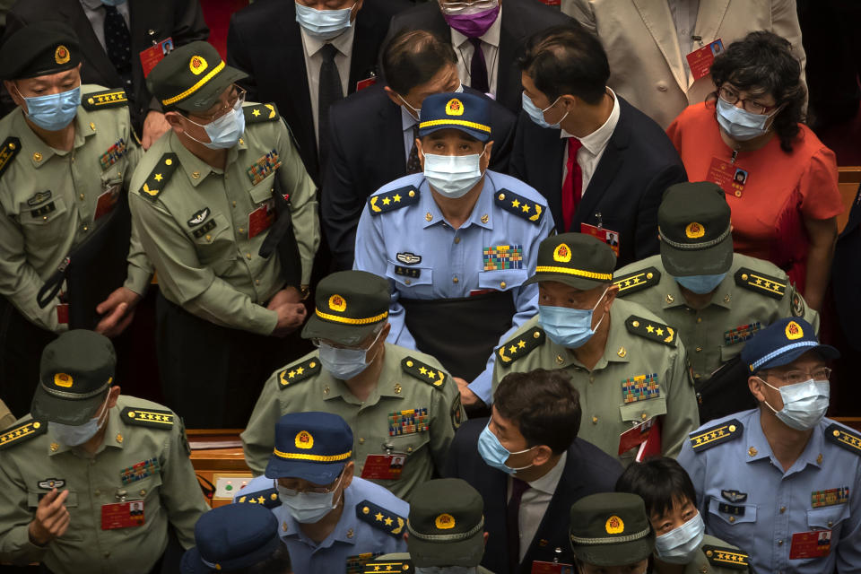 Military delegates wait to leave after the closing session of China's National People's Congress (NPC) at the Great Hall of the People in Beijing, Thursday, May 28, 2020. China's ceremonial legislature has endorsed a national security law for Hong Kong that has strained relations with the United States and Britain. (AP Photo/Mark Schiefelbein)