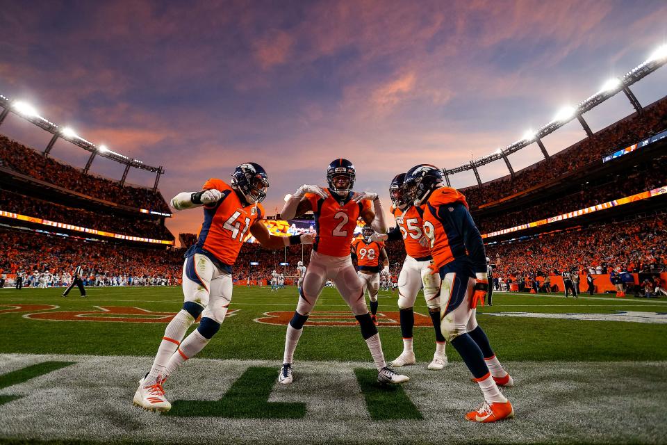 Denver Broncos cornerback Pat Surtain II (2) celebrates with teammates after scoring a touchdown on an interception.