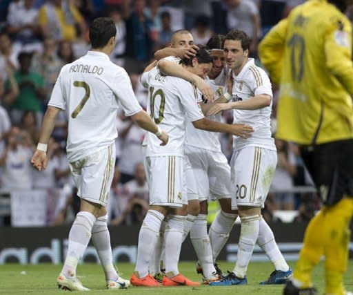 Real Madrid players celebrate after scoring during the Spanish league football match against Mallorcaon May 13. Mesut Ozil scored twice while Cristiano Ronaldo and Karim Benzema also hit the target during the match