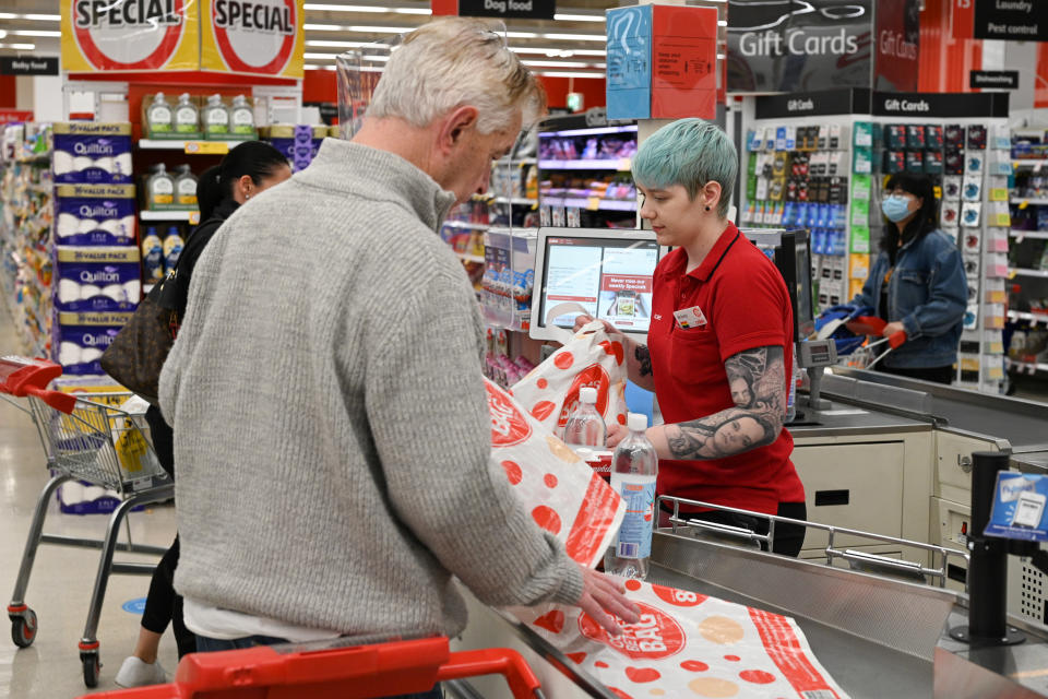 Coles cashier serving customers