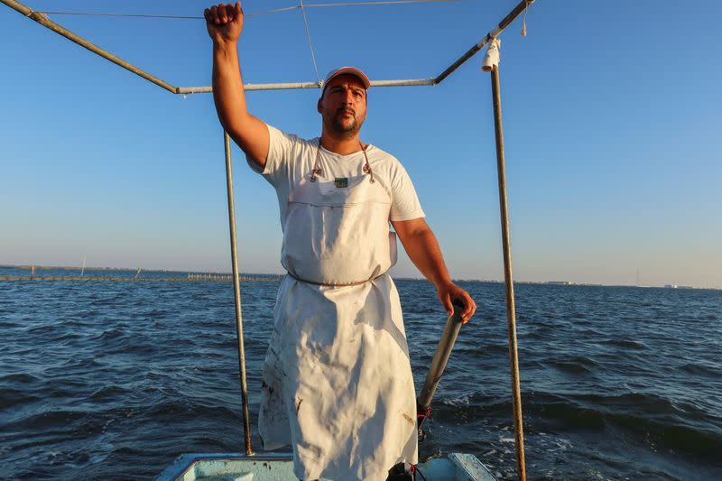 Fisherman Ahmed Chelli stands on his fishing boat around Tunisia's Kerkennah Islands