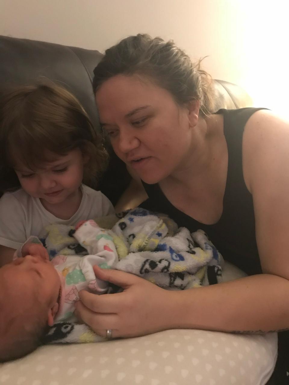 Casey Ward snuggles her two girls soon after the youngest was born.