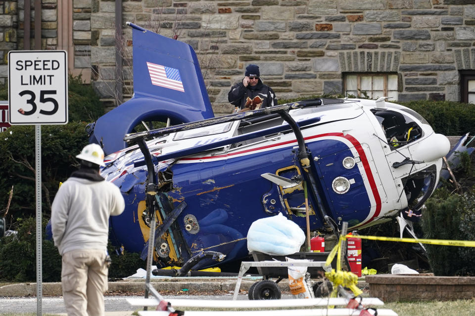 FILE - A medical helicopter rests next to the Drexel Hill United Methodist Church after it crashed the day before in the Drexel Hill section of Upper Darby, Pa., Jan. 12, 2022. The National Transportation Safety Board said in its final report dated Thursday, Jan. 4, 2024, that they have been unable to determine the exact cause of the crash of a medical helicopter that went down nearly two years ago without loss of life next to a church in the residential area of suburban Philadelphia, somehow avoiding a web of power lines and buildings. (AP Photo/Matt Rourke, File)