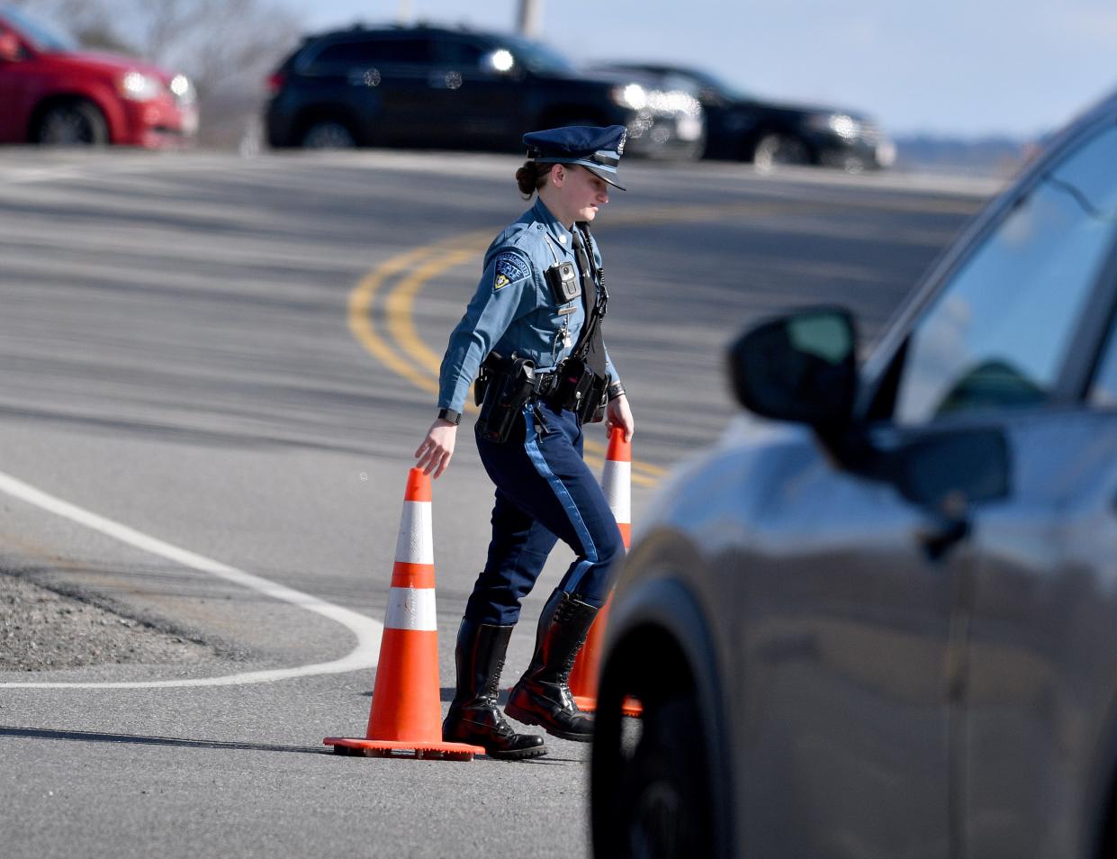 A state trooper sets up a roadblock at a report of a person with a weapon near Clinton schools Tuesday.