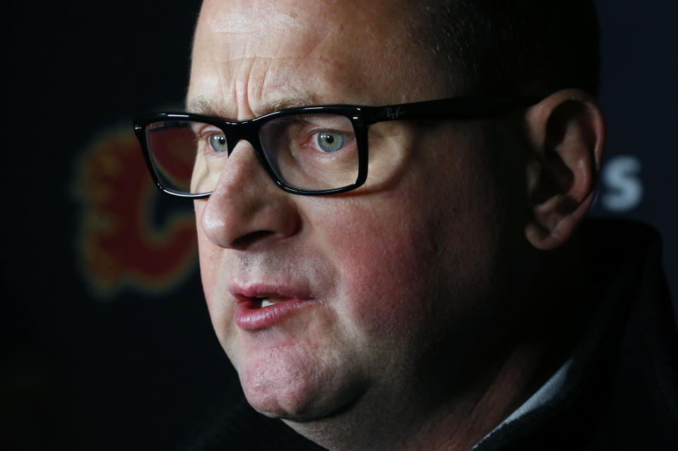 Calgary Flames General Manager Brad Treliving addresses the media following an NHL hockey practice Tuesday, Nov. 26, 2019, in Buffalo, N.Y. Treliving says Flames coach Bill Peters remains on the staff but wasn’t certain whether he’d be behind the bench for the next game. The team and the NHL are both investigating an allegation the Peters directed racial slurs at a player 10 years ago when the two were in the minors. Akim Aliu, a Nigerian-born player, says Peters “dropped the N bomb several times” in a dressing room during his rookie year.(AP Photo/Jeffrey T. Barnes)