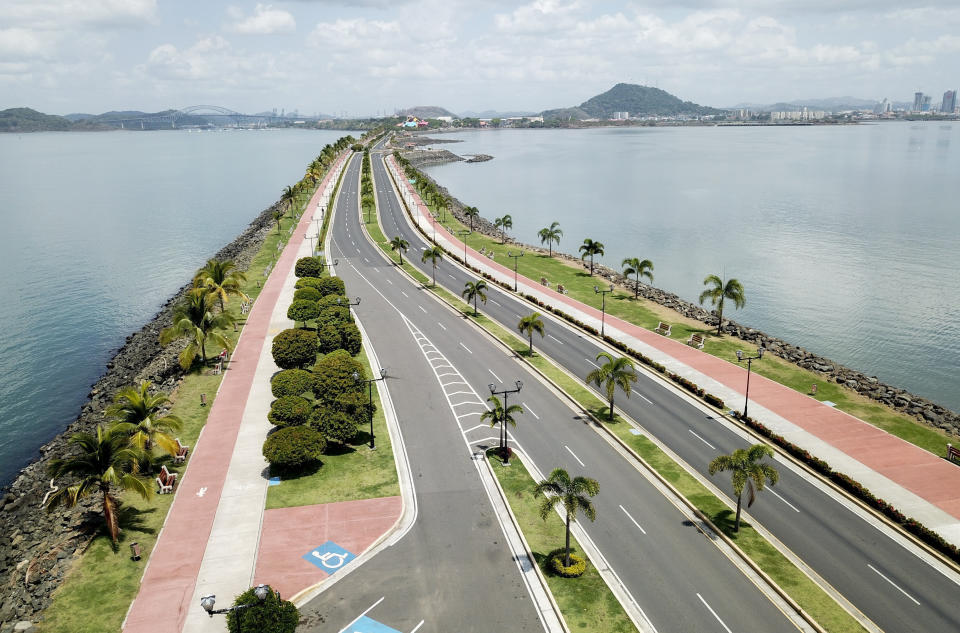 Panama City's causeway is seen devoid of traffic or pedestrians, as Panama hunkers down to confront the spread of the new coronavirus, early morning Sunday, March 22, 2020. The vast majority of people recover from the COVID-19 disease. (AP Photo/Arnulfo Franco)